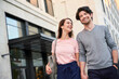 © philipp nemenz/Westend61 - Happy couple walking hand in hand in the city