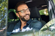 © Westend61 - Portrait of smiling man sitting in car