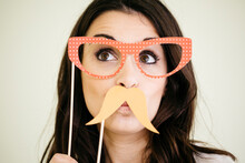 Portrait Of Young Woman With Comedy Glasses And Fake Moustache