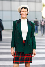 Portrait Of Smiling Fashionable Young Woman On Zebra Crossing