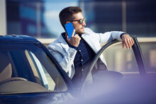 Young Businessman Standing At His Car, Talking On The Phone