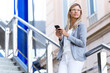 © Lifestock/Westend61 - Young businesswoman texting with her mobile phone on stairs