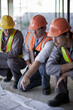 © LOUIS CHRISTIAN/Westend61 - Male architect explaining plans to construction workers on site