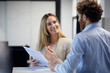 © Rainer Berg/Westend61 - Businessman and businesswoman working together on papers in office