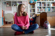 © Rainer Berg/Westend61 - Confident girl sitting cross-legged on floor of her room