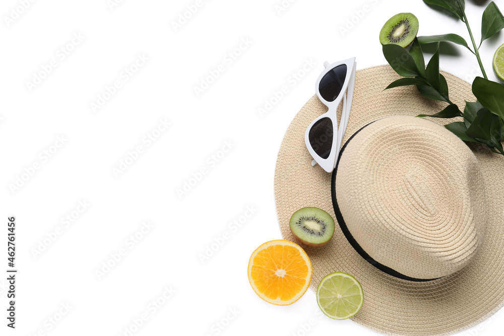 Composition with stylish hat, sunglasses and fruits on white background