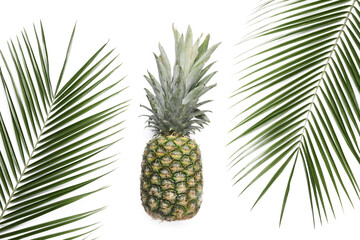  Ripe pineapple and palm leaves on white background