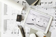 © Rainer Berg/Westend61 - ArchitecturalÔøΩblueprints and digital tablet displaying modern showcase interior