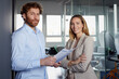 © Rainer Berg/Westend61 - Portrait of confident businessman and businesswoman in office