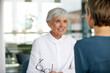© Rainer Berg/Westend61 - Portrait of senior businesswoman talking to colleague in office