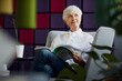 © Rainer Berg/Westend61 - Portrait of pensive senior businesswoman sitting on lounge chair