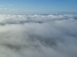 © Cameron Davidson/Westend61 - Aerial view of landscape shrouded by low clouds