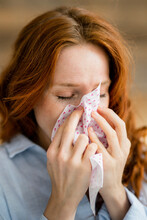 Redheaded Woman Blowing Nose