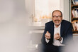 © Kniel Synnatzschke/Westend61 - Portrait of smiling mature businessman sitting in a cafe