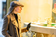 © GER/Westend61 - Caucasian woman doing window shopping at night
