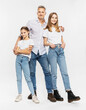 © Studio 27/Westend61 - Father and daughters standing together against white background