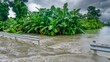 Floodwater on a highway pouring into a banana plantation and an agricultural field in a rural area near Calapan City on Mindoro Island in the Philippines.