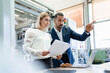 © Westend61 - Businessman and young woman with papers and laptop talking in a factory