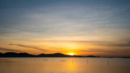 The Picture Nice sunset over sea and  mountain.