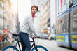 © Westend61 - Portrait of young man with bicycle in the city