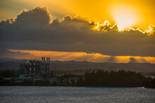 View Of Factory By Sea Against Cloudy Sky At Sunset, Puerto Rico, Caribbean
