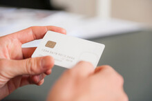 Hands Of Mid Adult Man Holding Blank White Credit Card
