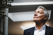 © Westend61 - Successful businessman looking up in satisfaction