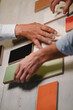 © BELLEVUE/Westend61 - Hands of architects choosing colour samples in office
