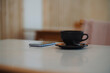 © Gustafsson/Westend61 - Smart phone and coffee cup on table in cafe