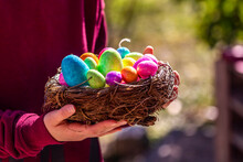 Girl Holding Easter Nest With Colorful Easter Eggs