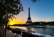 Eiffel Tower By Seine River Against Clear Blue Sky During Sunrise, Paris, France