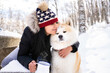 © Jose Carlos Ichiro/Westend61 - Woman with eyes closed embracing akita dog while holding coffee cup in winter