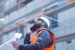 © Sigrid Gombert/Westend61 - Construction engineer on the phone at construction site