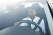 Woman seen through windshield while driving car