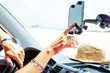 © Westend61 - Close-up of woman using navigation on smart phone in van