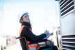 © Sigrid Gombert/Westend61 - Young technician with safety helmet and vest in wheelchair working outdoors