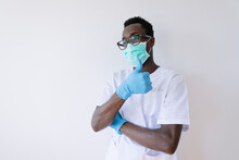Afro Doctor Wearing Surgical Mask Showing Thumbs Up While Standing Against White Background