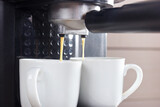 Fototapeta Mapy - Making two cups of espresso in horn coffee maker.