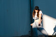 © Manu Prats/Westend61 - Female hip-hop dancer puckering lips while dancing against white wall during sunny day