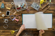 © Laia Divols Escude/Westend61 - Top view of woman's hands preparing a scrapbook