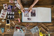 © Laia Divols Escude/Westend61 - Top view of woman's hands designing photo album