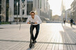 © Westend61 - Businessman riding kick scooter in the city