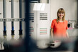 © KNSY/Westend61 - Smiling female entrepreneur standing against control panel in greenhouse