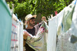 © victor espadas/Westend61 - Man hanging up laundry outdoors