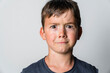© Giorgio Magini/Westend61 - Portrait of boy, doubting, white background