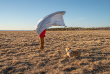 Dog And Boy With Superhero Costume In Steppe Landscape