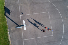 Young Man And Woman Playing Basketball, Aerial View