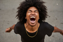 Portrait Of Screaming Young Man With Afro