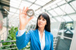 © Joseffson/Westend61 - Businesswoman examining equipment in office