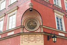 Ornamented Historic Clock At Facade Of A House At Market Square In The Old Town, Warsaw, Poland